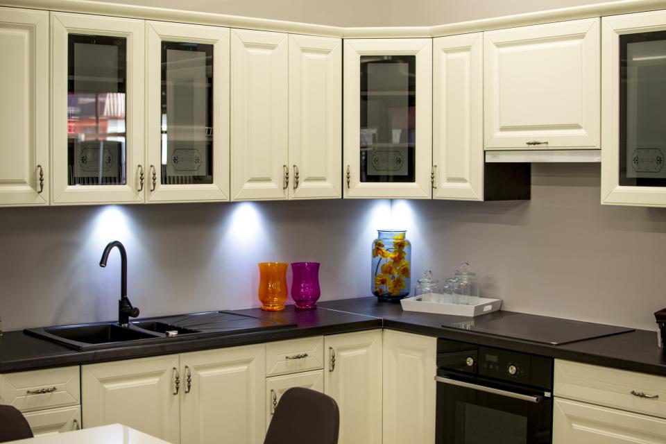 Cream-painted kitchen cabinets with a dark countertop